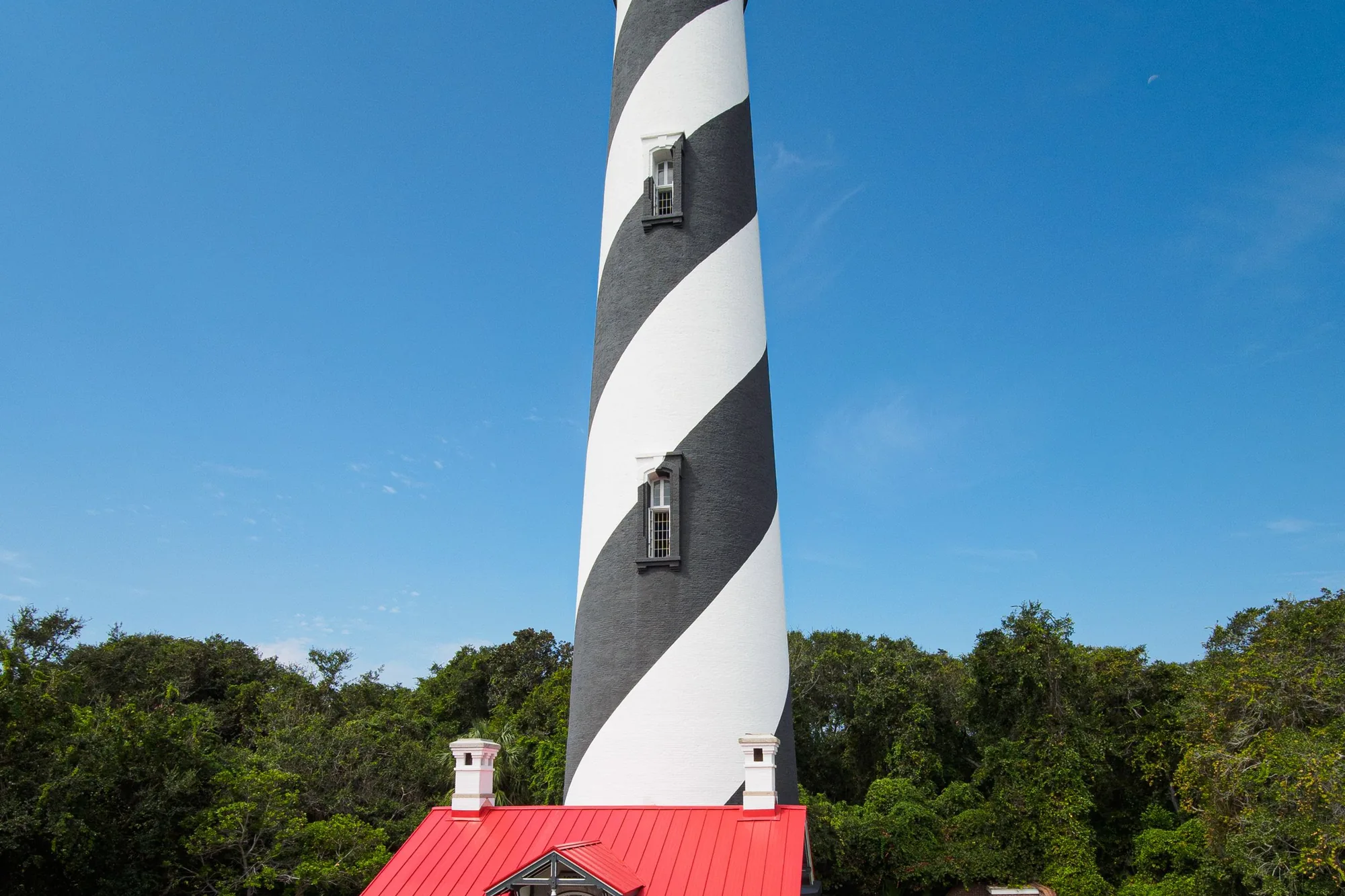 The St. Augustine Lighthouse's black-and-white spiral tower above its red-roofed keeper's house